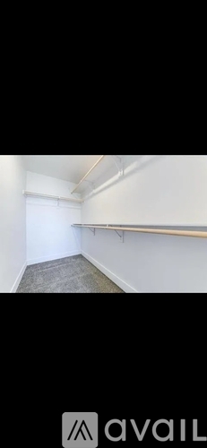 A room with a carpeted floor and white walls.