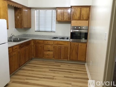 A kitchen with wooden cabinets and a white refrigerator.