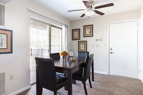 A dining room with a table and chairs.
