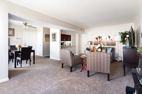 A living room with a dining table and chairs.