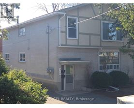A building with a sign that says EXIT EXCEL REALTY, Brokerage.