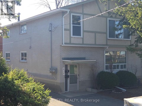 A building with a sign that says EXIT EXCEL REALTY, Brokerage.