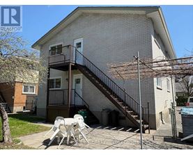 A house with a balcony and a staircase leading to the second floor.