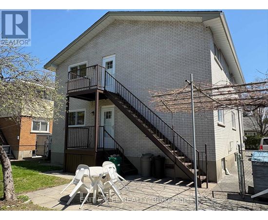 A house with a balcony and a staircase leading to the second floor.