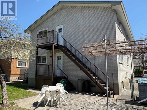 A house with a balcony and a staircase leading to the second floor.