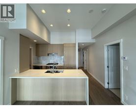 A modern kitchen with a large island and a sink.