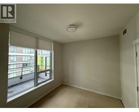 A room with a window overlooking a balcony.