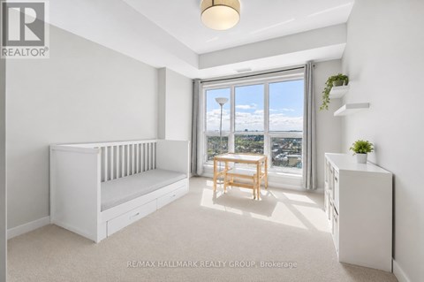 A white bedroom with a window seat and a wooden table.