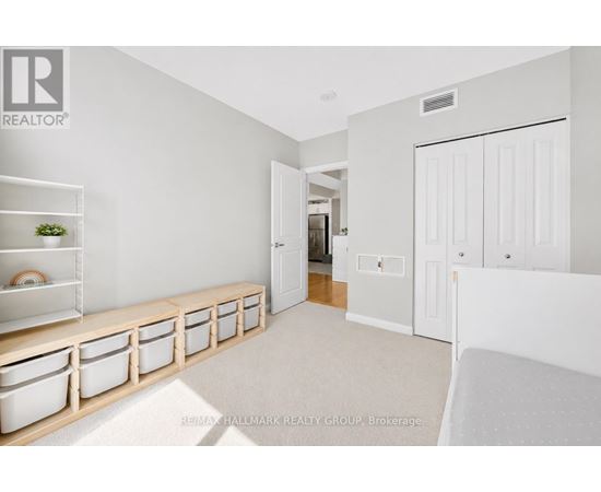 A white room with a long bench and a door.