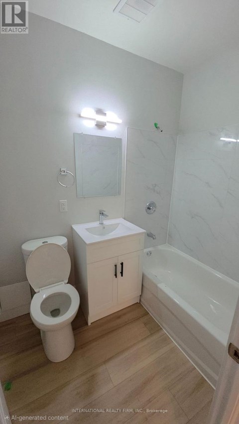 A white toilet sits next to a sink in a small bathroom.