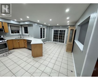 A kitchen with a tile floor and a large island in the middle.