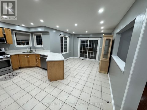 A kitchen with a tile floor and a large island in the middle.