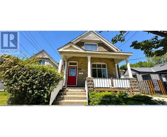 A small house with a red door is for sale.