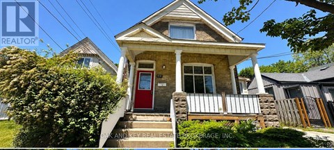 A small house with a red door is for sale.