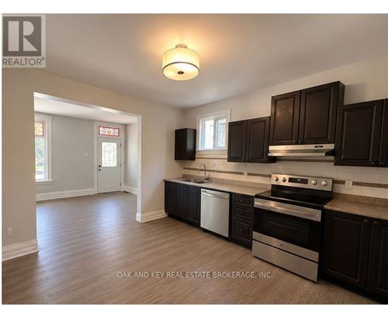 A kitchen with dark brown cabinets and stainless steel appliances.