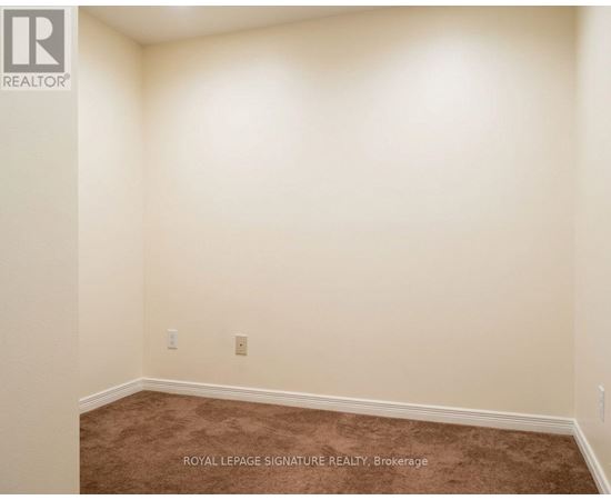 A room with a carpet floor and a white wall.