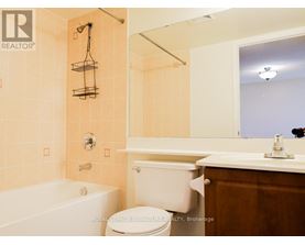 A bathroom with a toilet, sink, and bathtub.