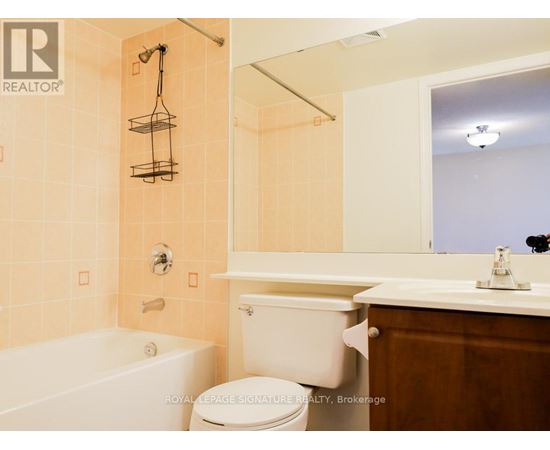 A bathroom with a toilet, sink, and bathtub.