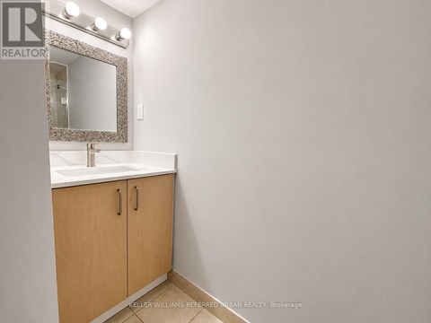 A bathroom with a sink, mirror and cabinets.