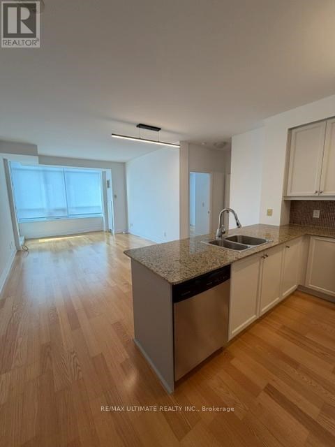 A kitchen with a sink and a dishwasher.