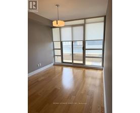 A room with a wooden floor and a large window.