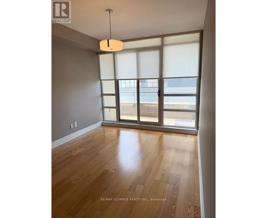 A room with a wooden floor and a large window.