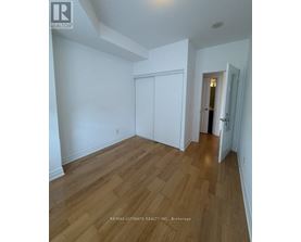 A room with wood flooring and white walls.