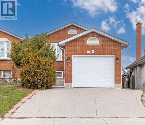 A red brick house with a white garage door.