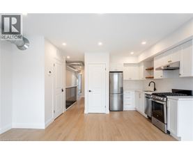 A modern kitchen with white cabinets and stainless steel appliances.