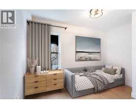 A bedroom with a bed, dresser, and a painting on the wall.