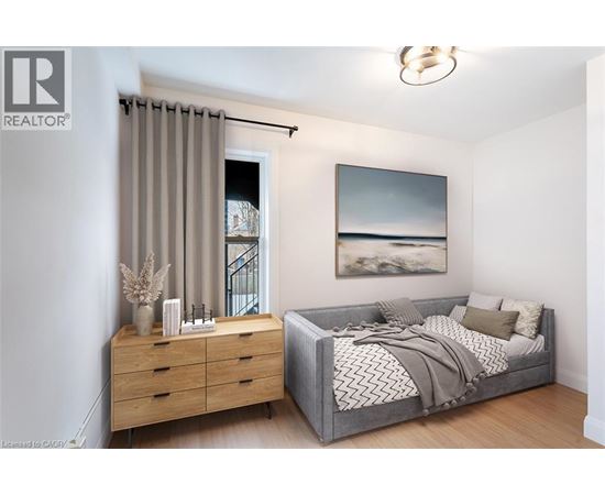 A bedroom with a bed, dresser, and a painting on the wall.