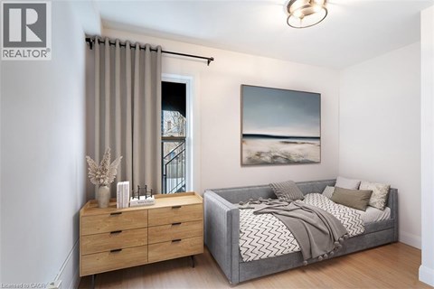 A bedroom with a bed, dresser, and a painting on the wall.