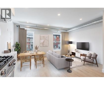 A modern living room with a dining table and a sofa.