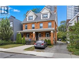 A two-story house with a car parked in front.