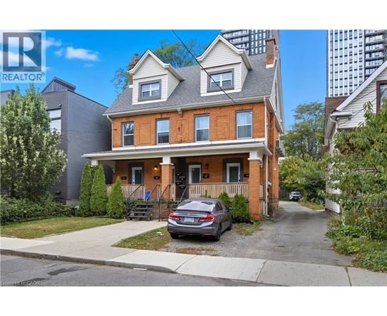 A two-story house with a car parked in front.