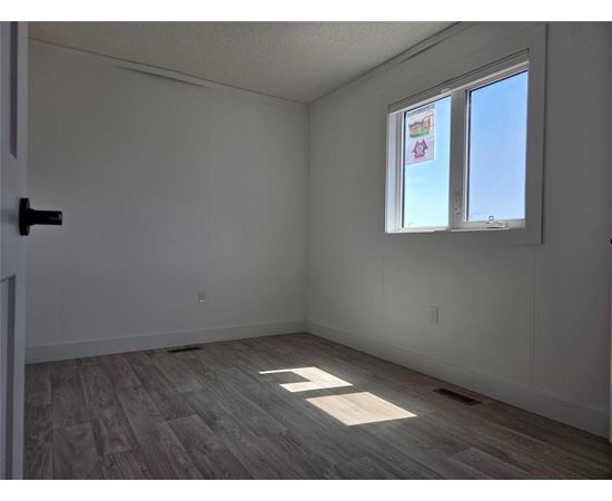A room with a window and a door.