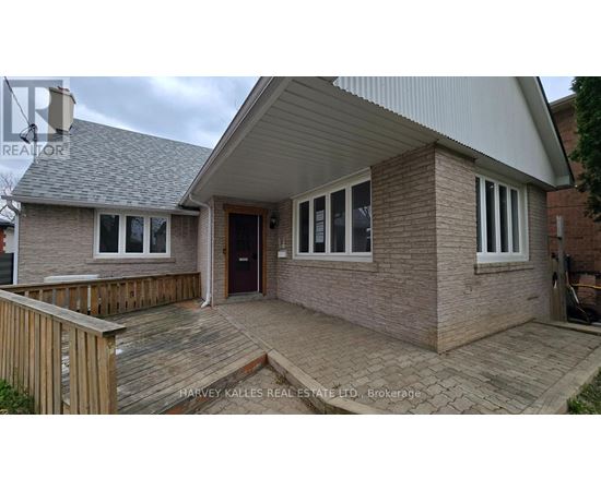 A house with a brown brick exterior and a grey roof.