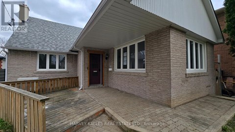 A house with a brown brick exterior and a grey roof.