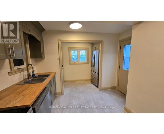 A kitchen with a sink and a window.