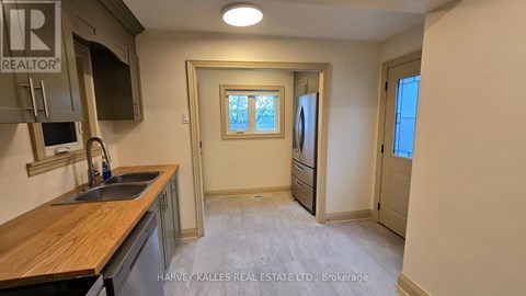 A kitchen with a sink and a window.