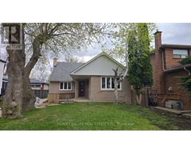 A house with a tree in front of it is for sale.