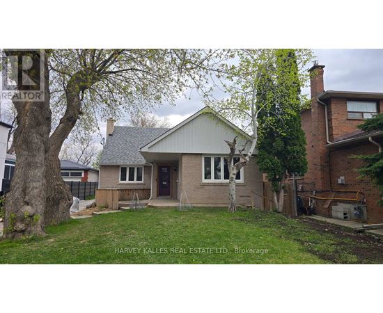 A house with a tree in front of it is for sale.