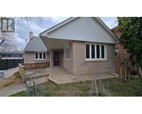 A small house with a brick exterior and a pitched roof.