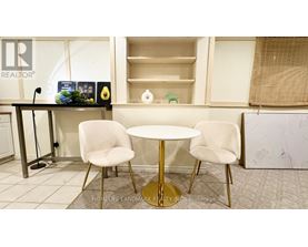 A realtor's office with a table and chairs.