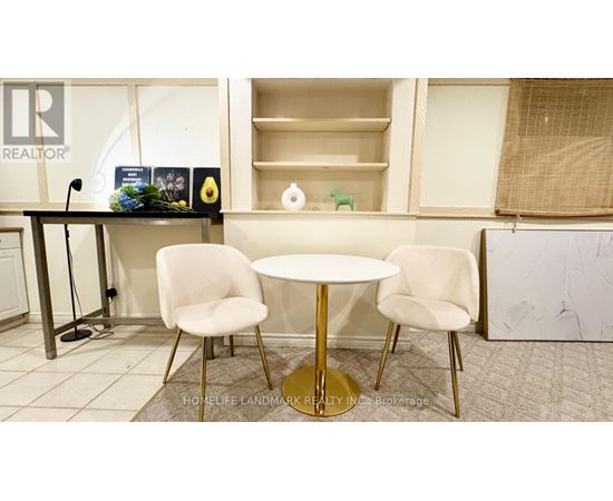 A realtor's office with a table and chairs.