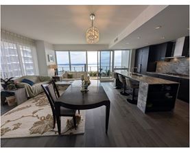A modern dining room with a view of the water.