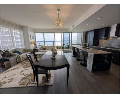 A modern dining room with a view of the water.