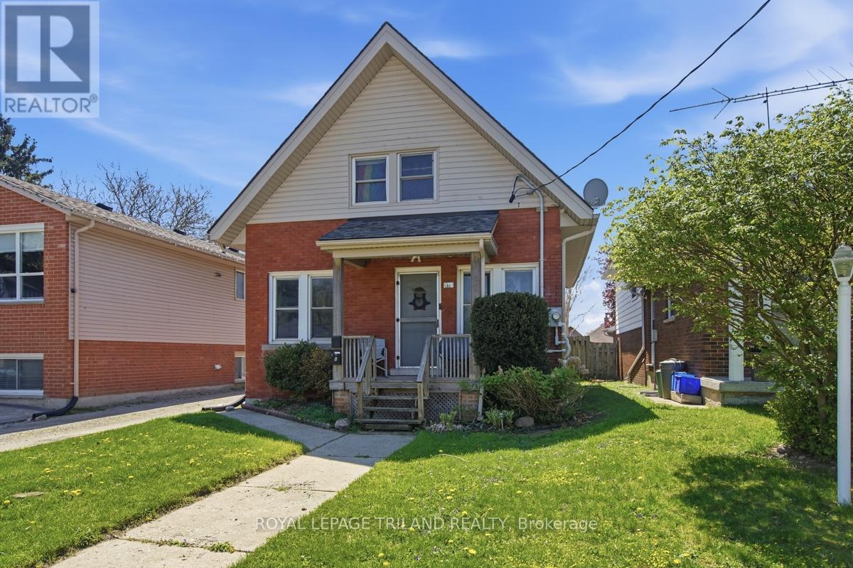 A house with a red brick exterior and a white front porch.