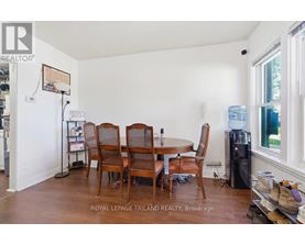 A dining room with a table and chairs.