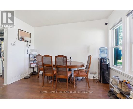 A dining room with a table and chairs.